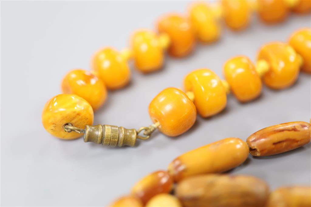 Two Chinese single strand amber necklaces.
